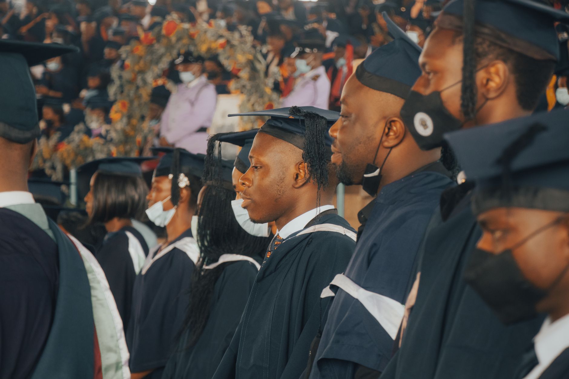 Graduates in caps and gowns at a university commencement ceremony
