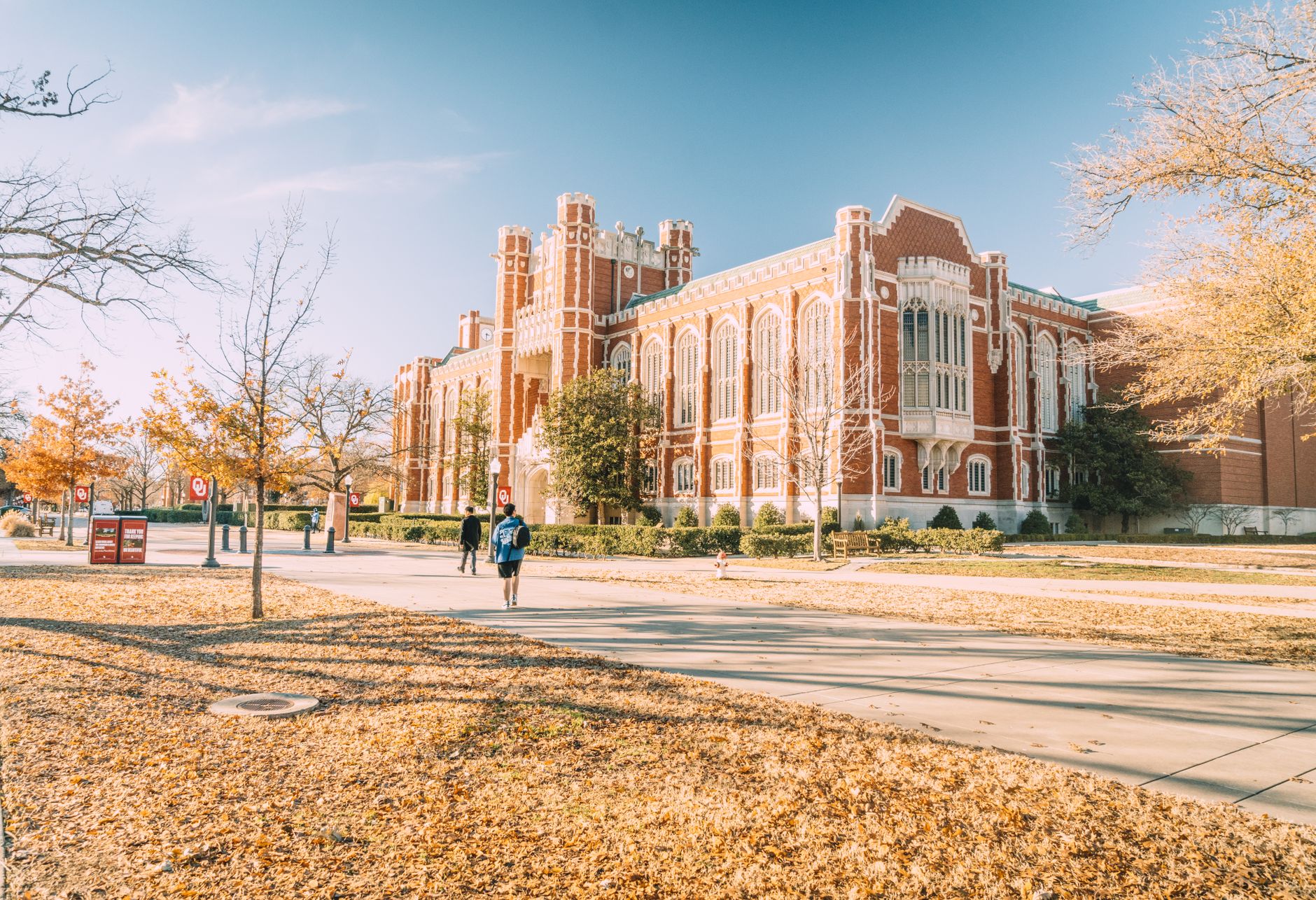 A historic university campus building on a tree-lined quad